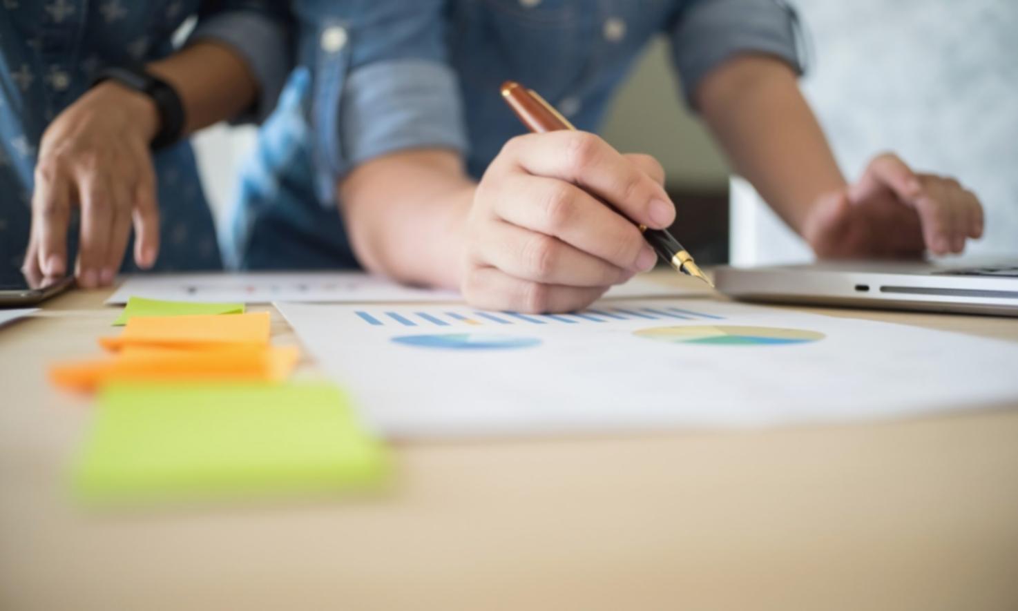 Professional reviewing financial reports and budget analysis documents